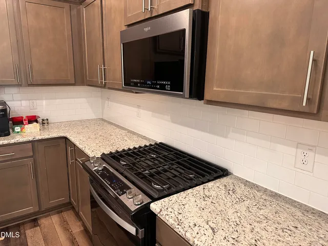 a stove top oven sitting inside of a kitchen
