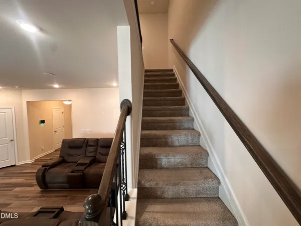 a view of entryway and hall with wooden floor