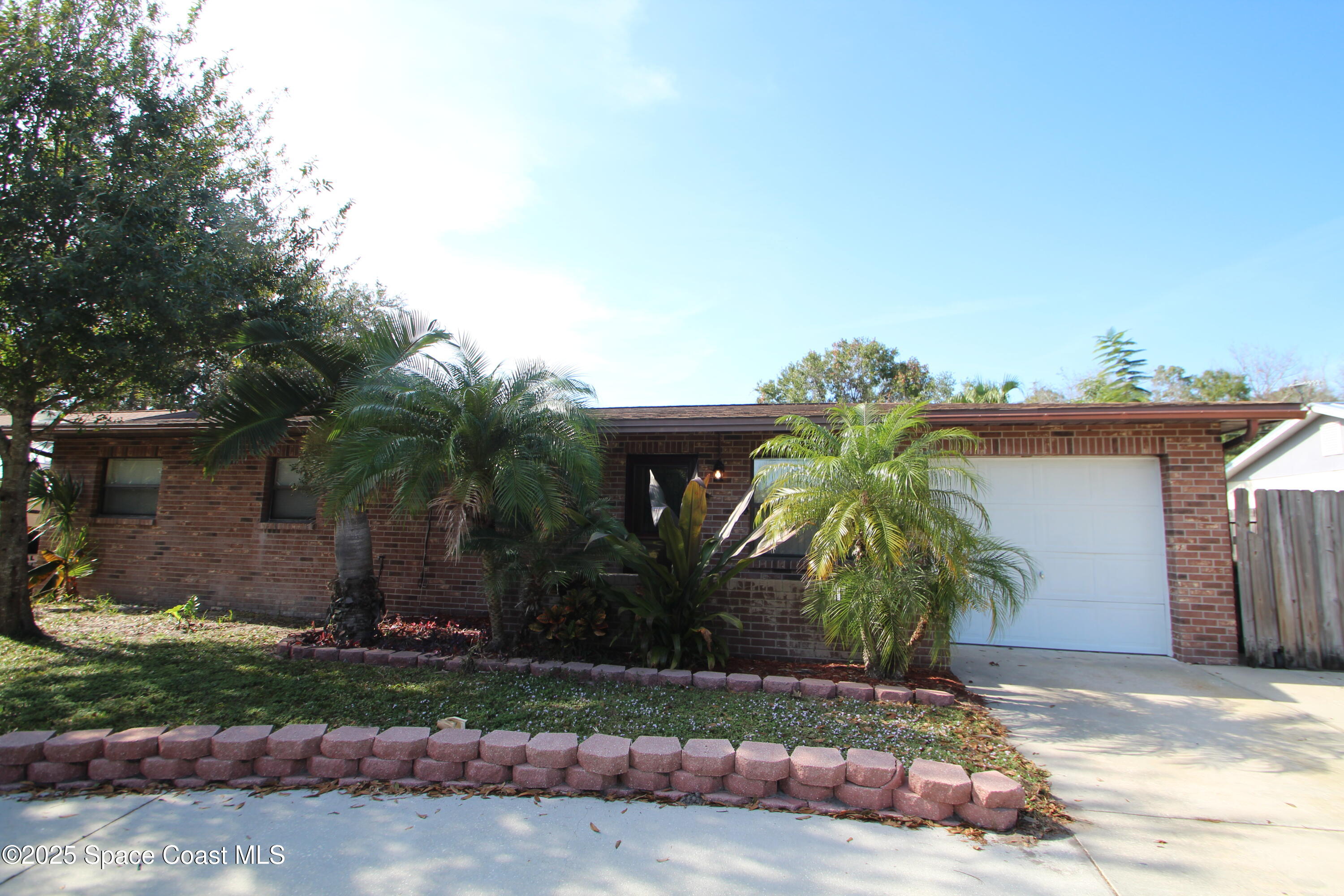 165 Virginia Road Melbourne, FL 32904 - Photo 1 of 32 a front view of a house with garden