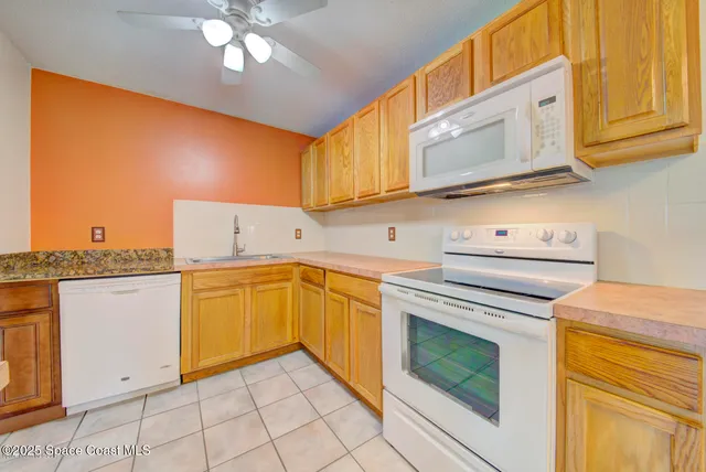 a kitchen with granite countertop cabinets and appliances