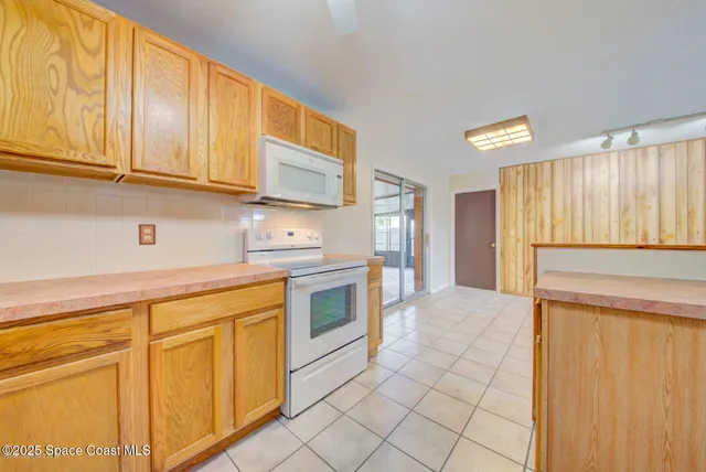 a view of a hallway with a chandelier fan