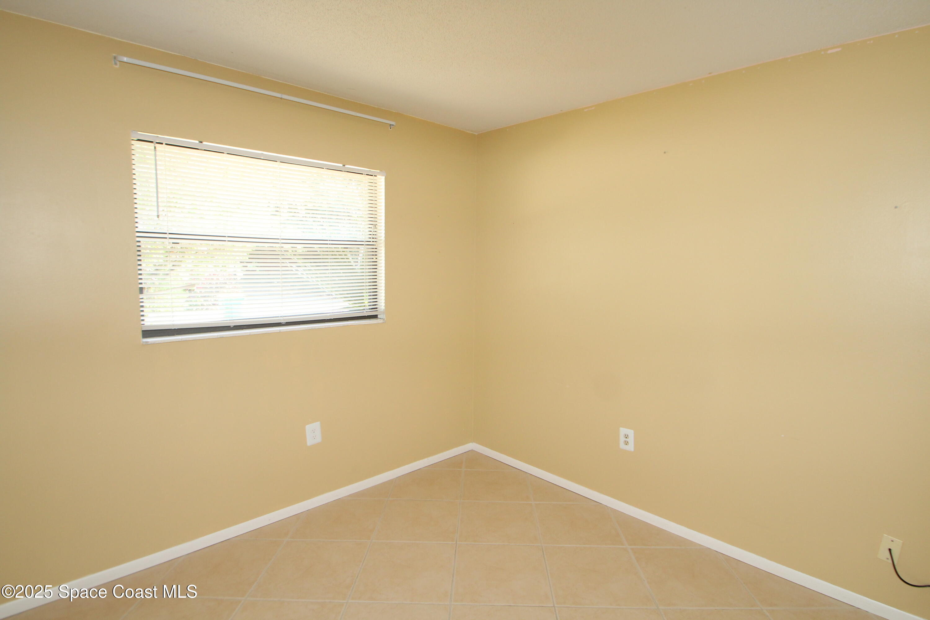 165 Virginia Road Melbourne, FL 32904 - Photo 16 of 32 a view of an empty room with a window