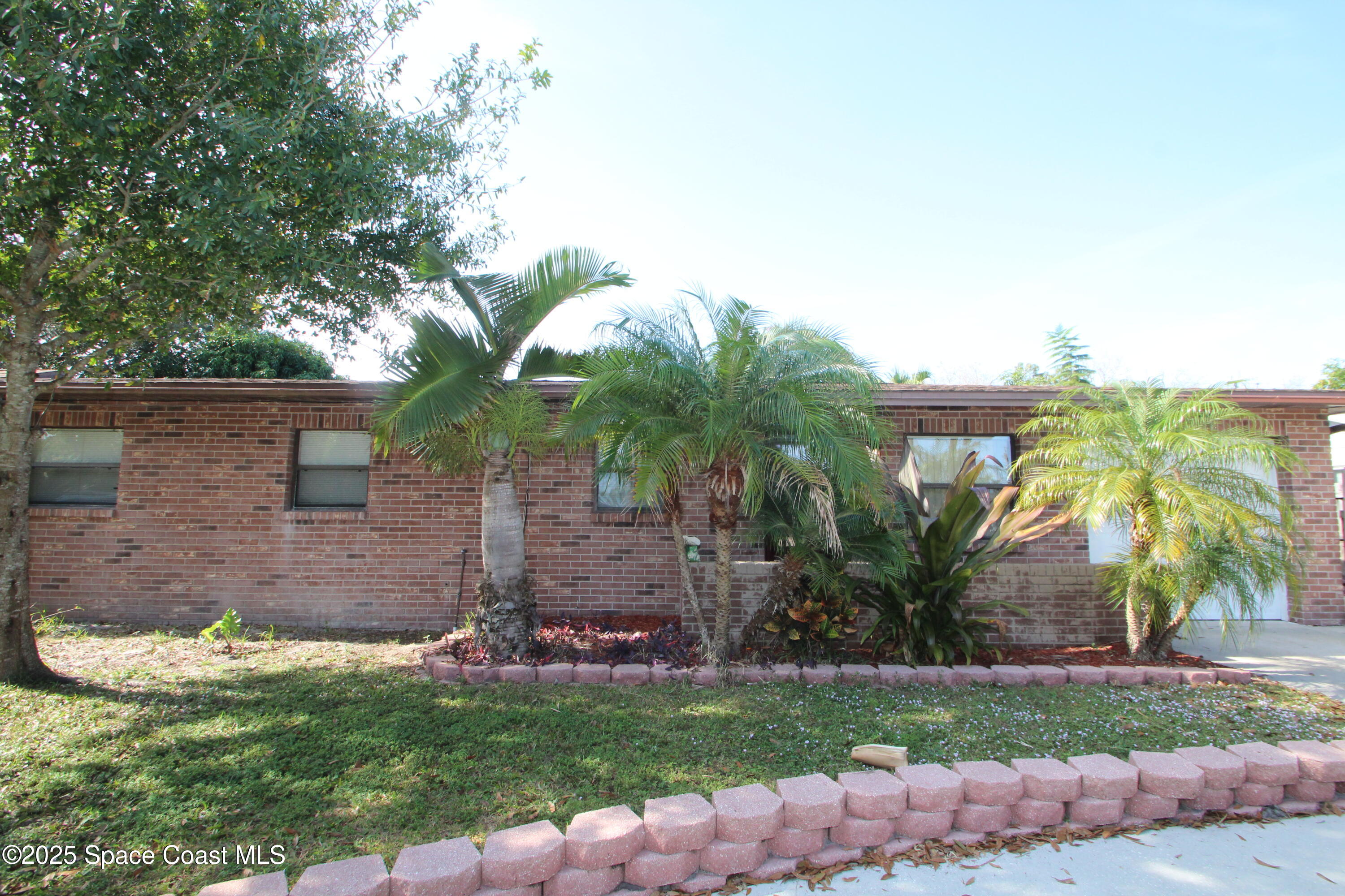 165 Virginia Road Melbourne, FL 32904 - Photo 2 of 32 front view of house with a yard