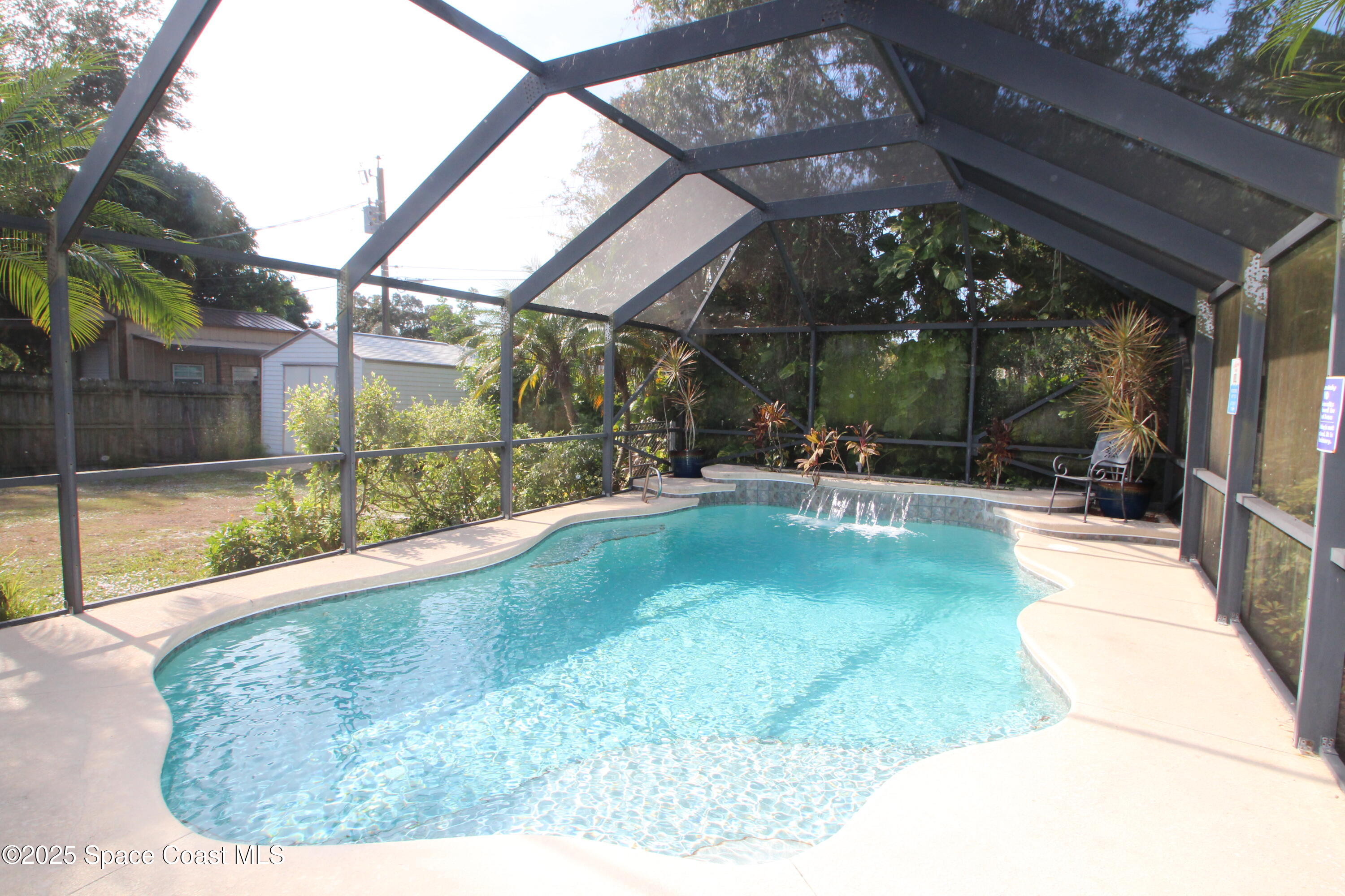 165 Virginia Road Melbourne, FL 32904 - Photo 24 of 32 a view of a swimming pool with a patio