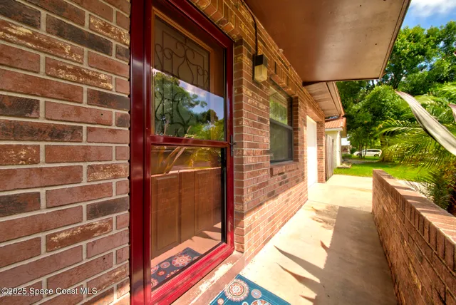 a view of an empty room with window and a bathroom