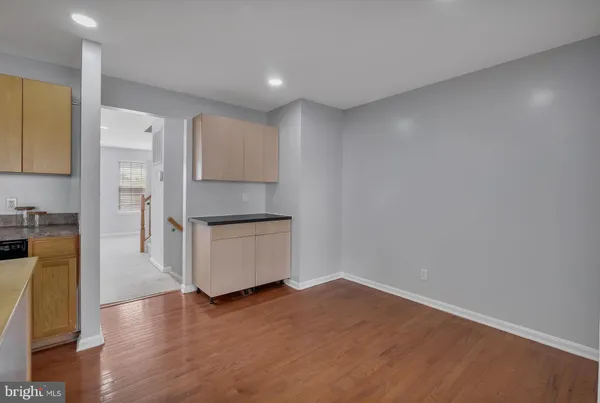 a kitchen with a refrigerator and a stove top oven