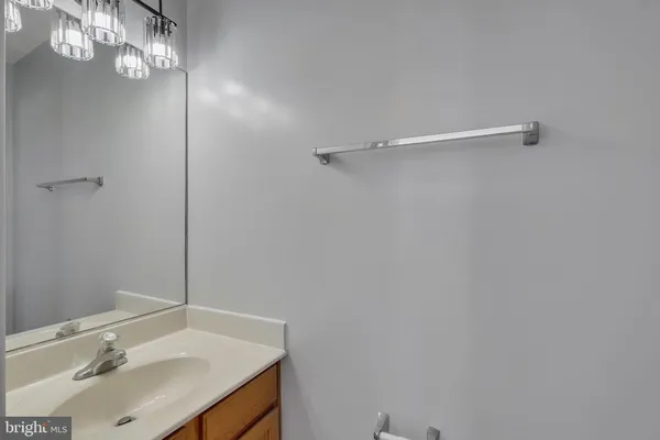 a bathroom with a sink vanity and a mirror