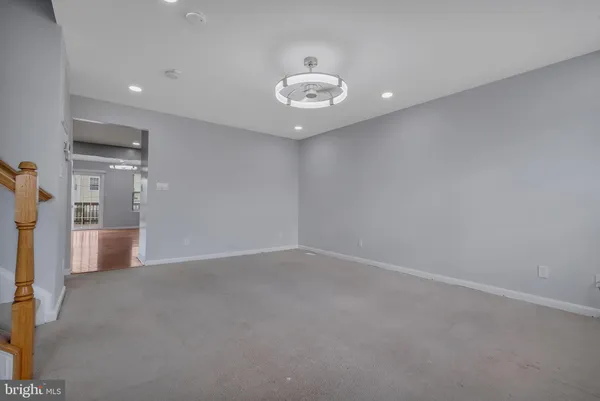 a view of an empty room with a kitchen