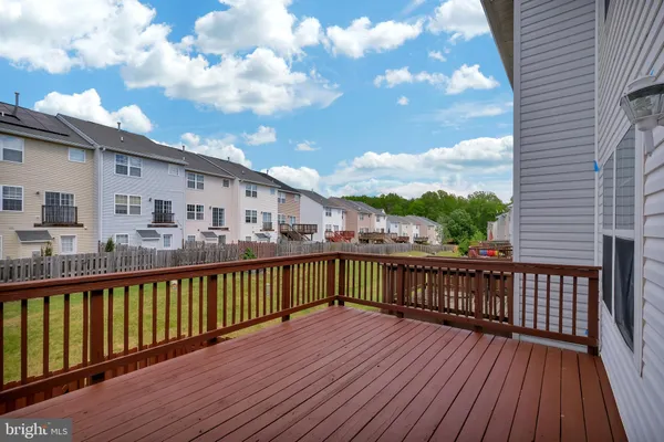a view of a wooden deck with large trees