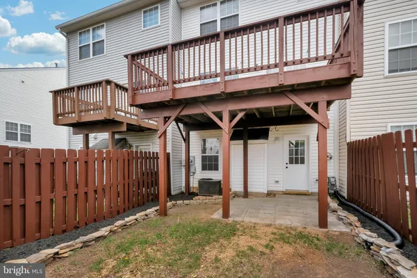 a view of a house with wooden fence