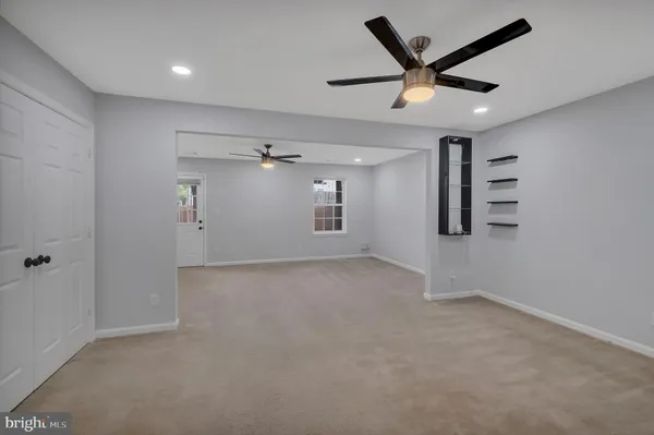 a view of a big room with wooden floor and windows