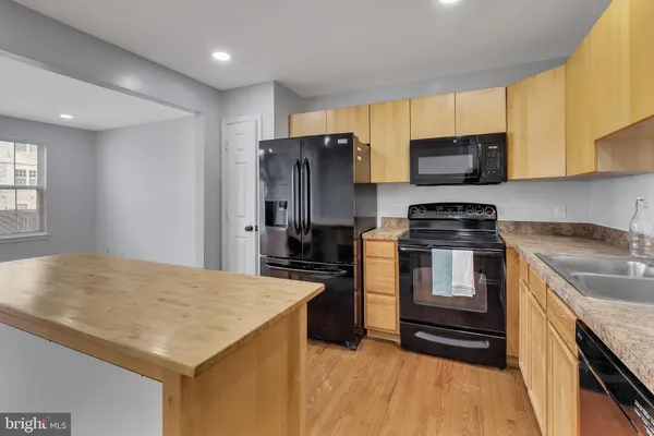 a kitchen with stainless steel appliances a stove microwave and refrigerator