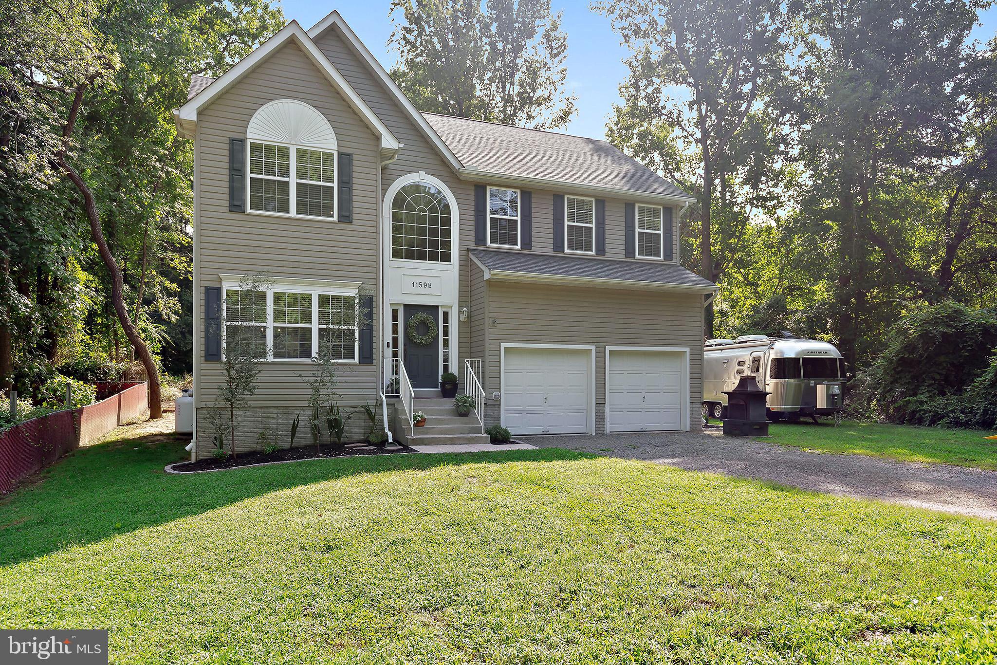 11598 Big Sandy Run Road Lusby, MD 20657 - Photo 1 of 30 a front view of a house with a yard and garage