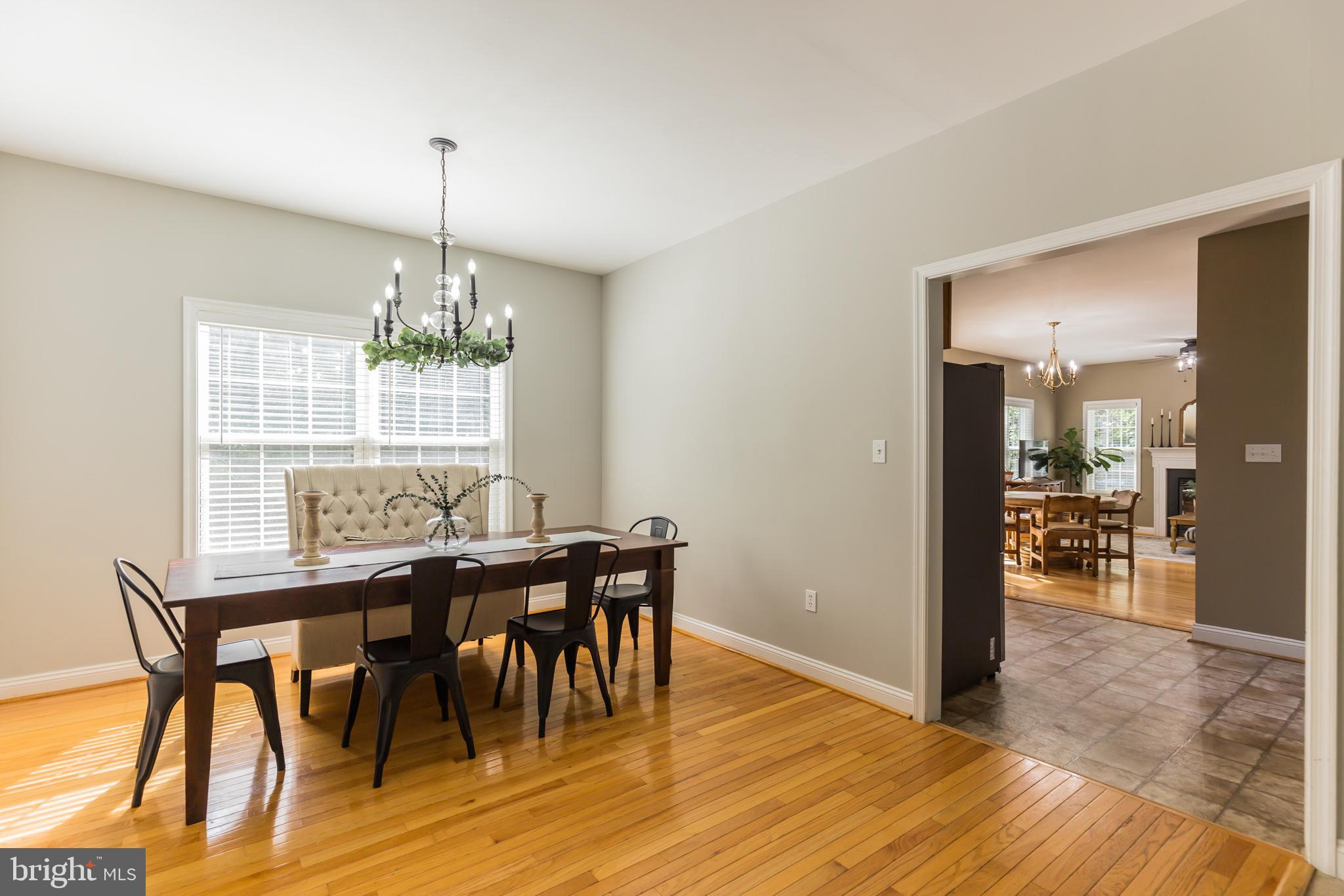 11598 Big Sandy Run Road Lusby, MD 20657 - Photo 13 of 30 a view of a dining room with furniture wooden floor and chandelier