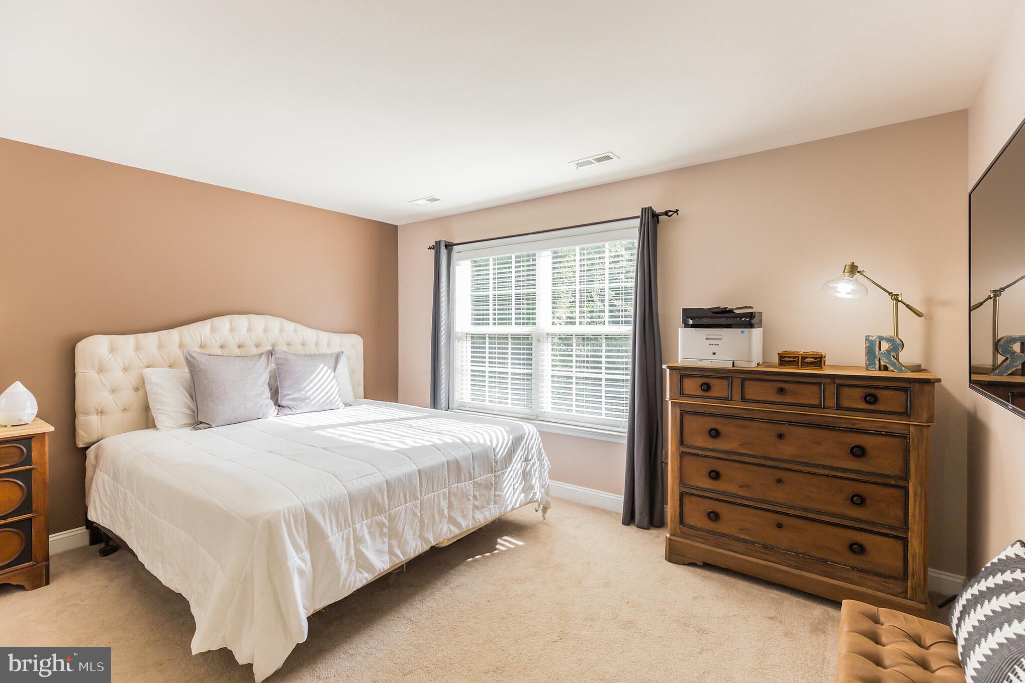 11598 Big Sandy Run Road Lusby, MD 20657 - Photo 17 of 30 a bedroom with a bed and a dresser