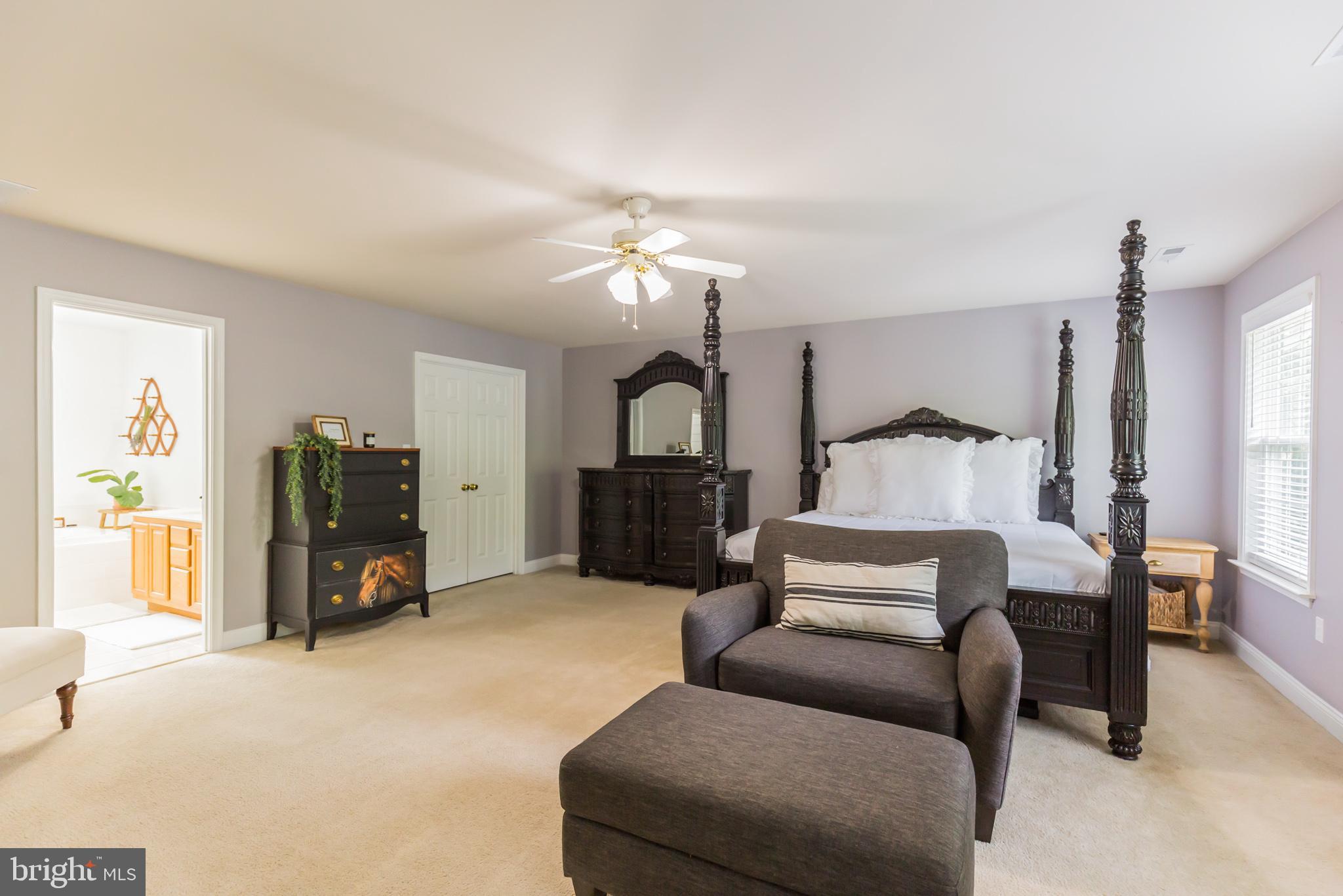 11598 Big Sandy Run Road Lusby, MD 20657 - Photo 20 of 30 a bedroom with a bed a couch and a chandelier