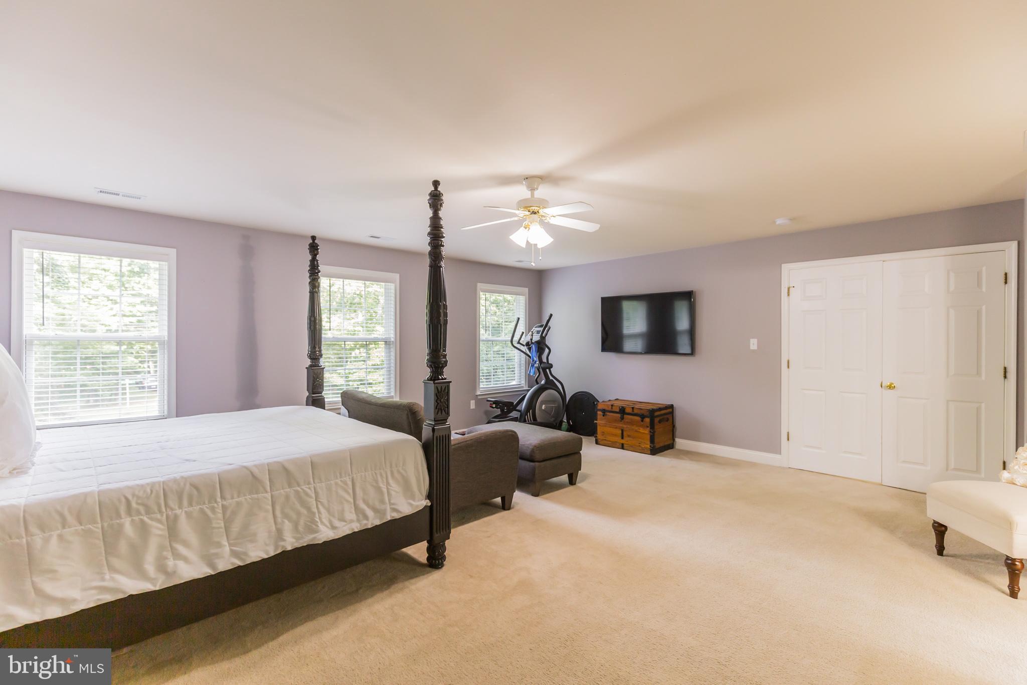 11598 Big Sandy Run Road Lusby, MD 20657 - Photo 21 of 30 a bedroom with a bed and large flat screen tv