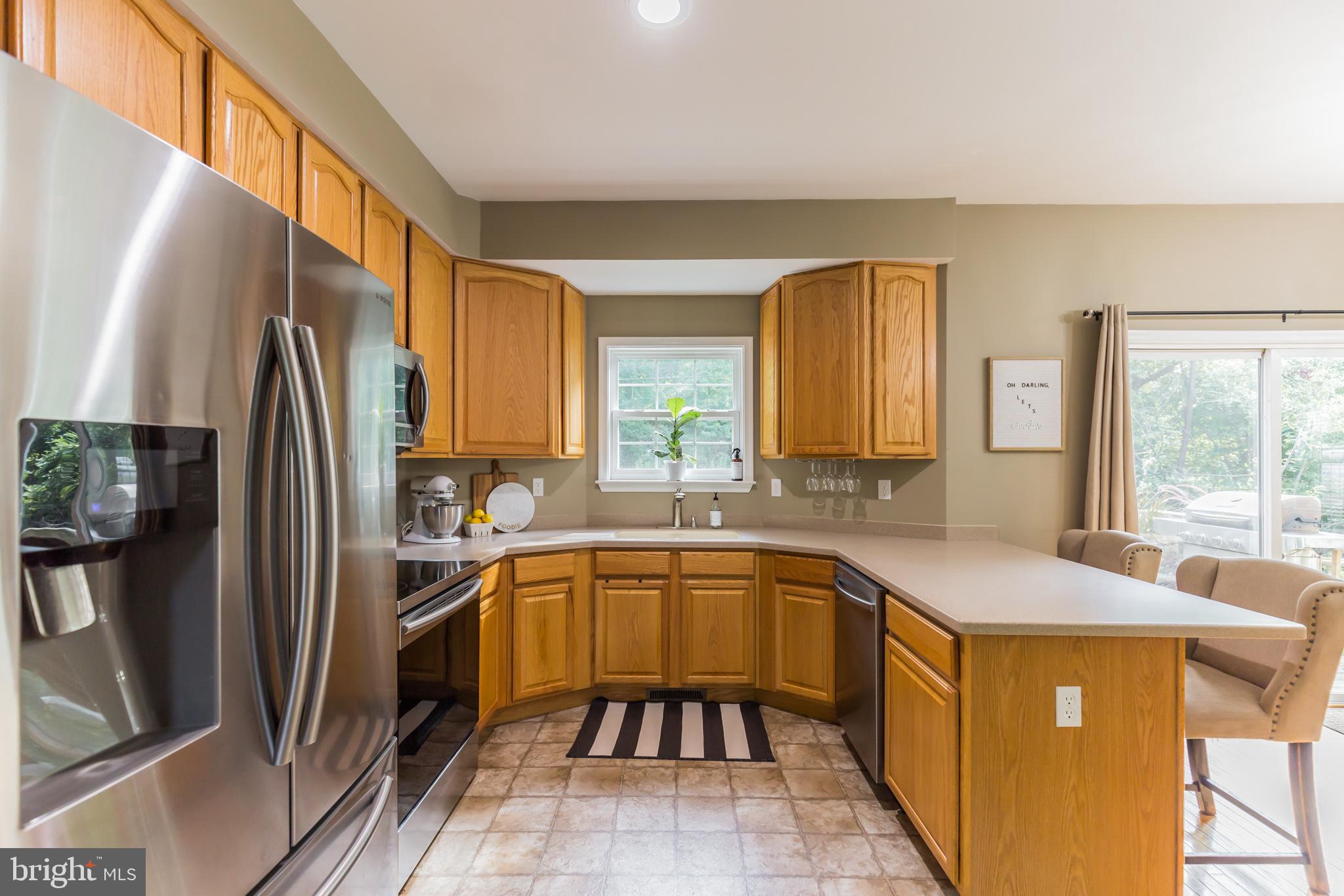 11598 Big Sandy Run Road Lusby, MD 20657 - Photo 5 of 30 a kitchen with a sink refrigerator and cabinets