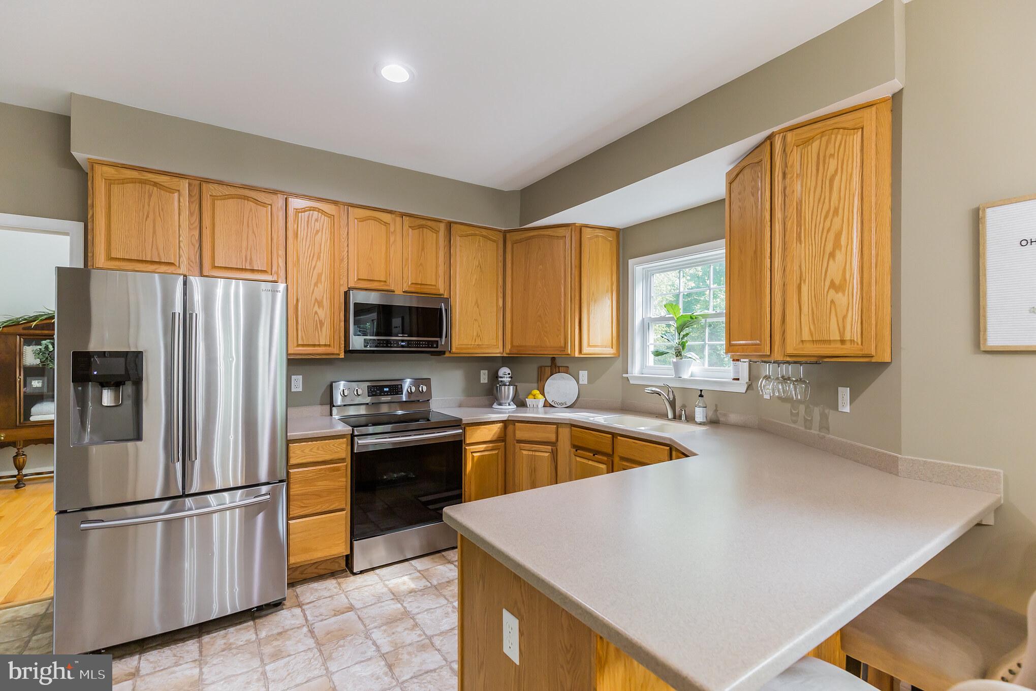 11598 Big Sandy Run Road Lusby, MD 20657 - Photo 6 of 30 a kitchen with stainless steel appliances granite countertop a refrigerator a sink dishwasher a stove and a refrigerator
