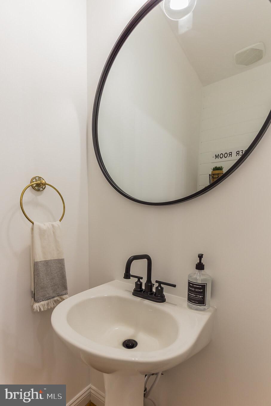 11598 Big Sandy Run Road Lusby, MD 20657 - Photo 10 of 30 a bathroom with a sink and mirror