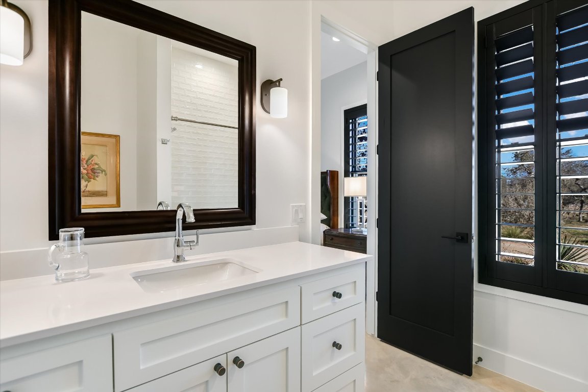 343 Pug Rippy Road Dripping Springs, TX 78620 - Photo 18 of 33 a bathroom with a sink and a mirror