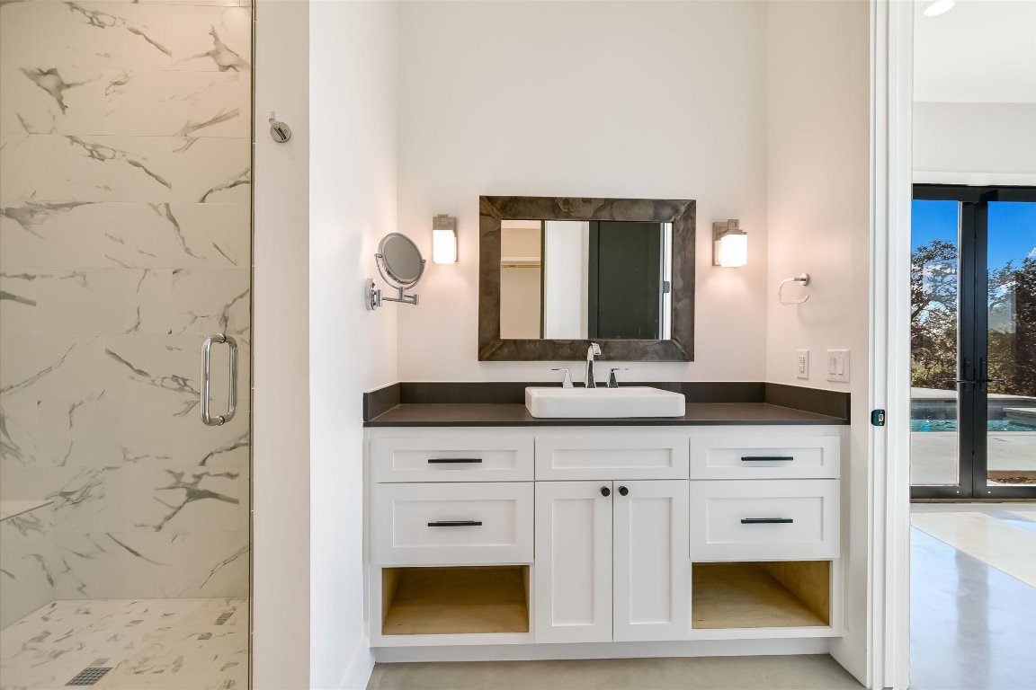 343 Pug Rippy Road Dripping Springs, TX 78620 - Photo 23 of 33 a bathroom with a sink and a mirror