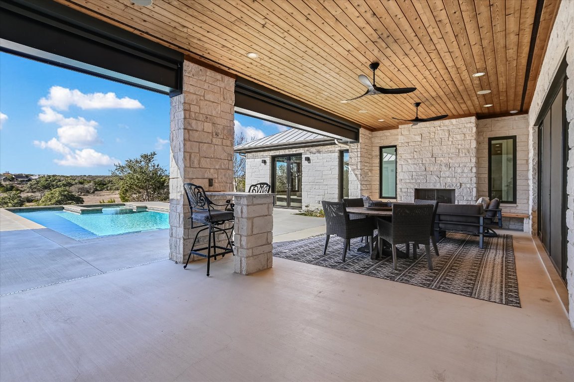 343 Pug Rippy Road Dripping Springs, TX 78620 - Photo 24 of 33 a view of a patio with table and chairs