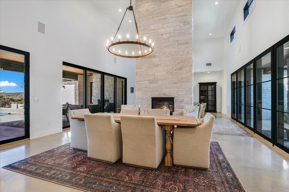 343 Pug Rippy Road Dripping Springs, TX 78620 - Photo 8 of 33 a living room with a couch and a chandelier
