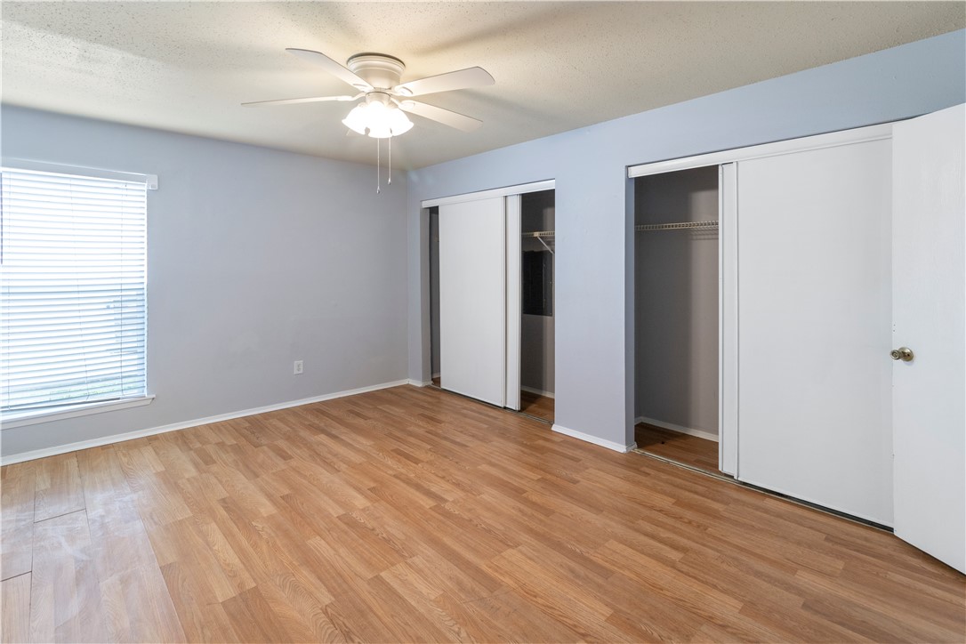 1014 Autumn Circle, Unit A College Station, TX 77840 - Photo 13 of 16 wooden floor in an empty room with a window