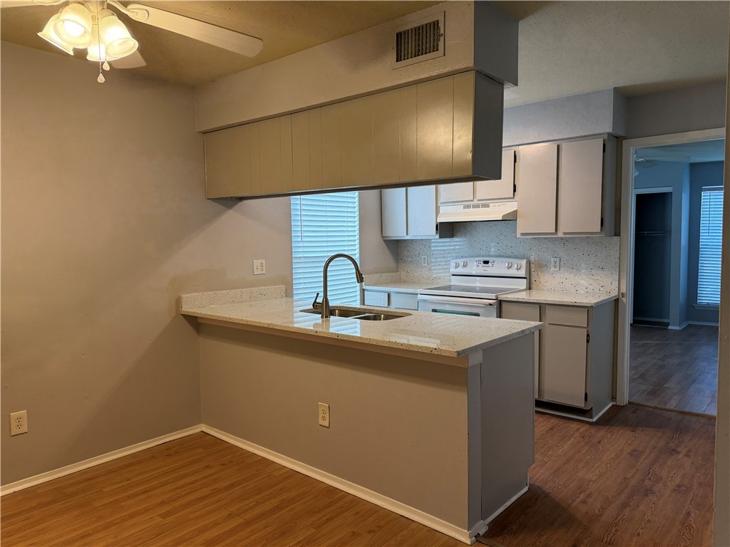 1014 Autumn Circle, Unit A College Station, TX 77840 - Photo 5 of 16 a kitchen with sink and cabinets