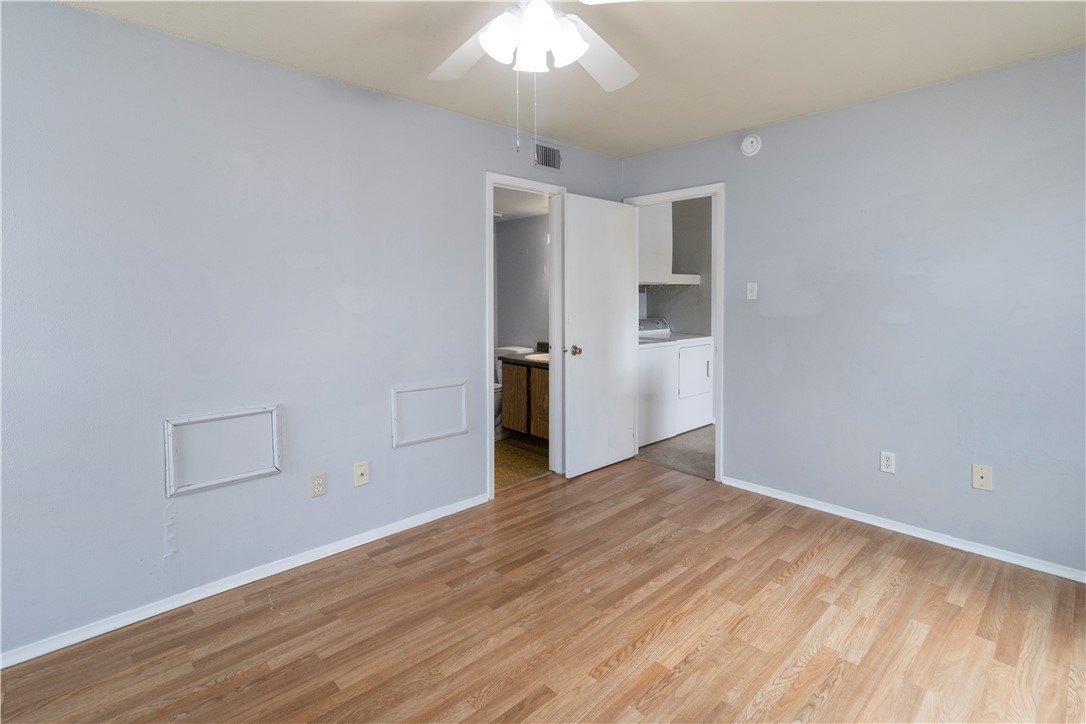 1014 Autumn Circle, Unit A College Station, TX 77840 - Photo 10 of 16 a view of empty room with wooden floor and ceiling fan