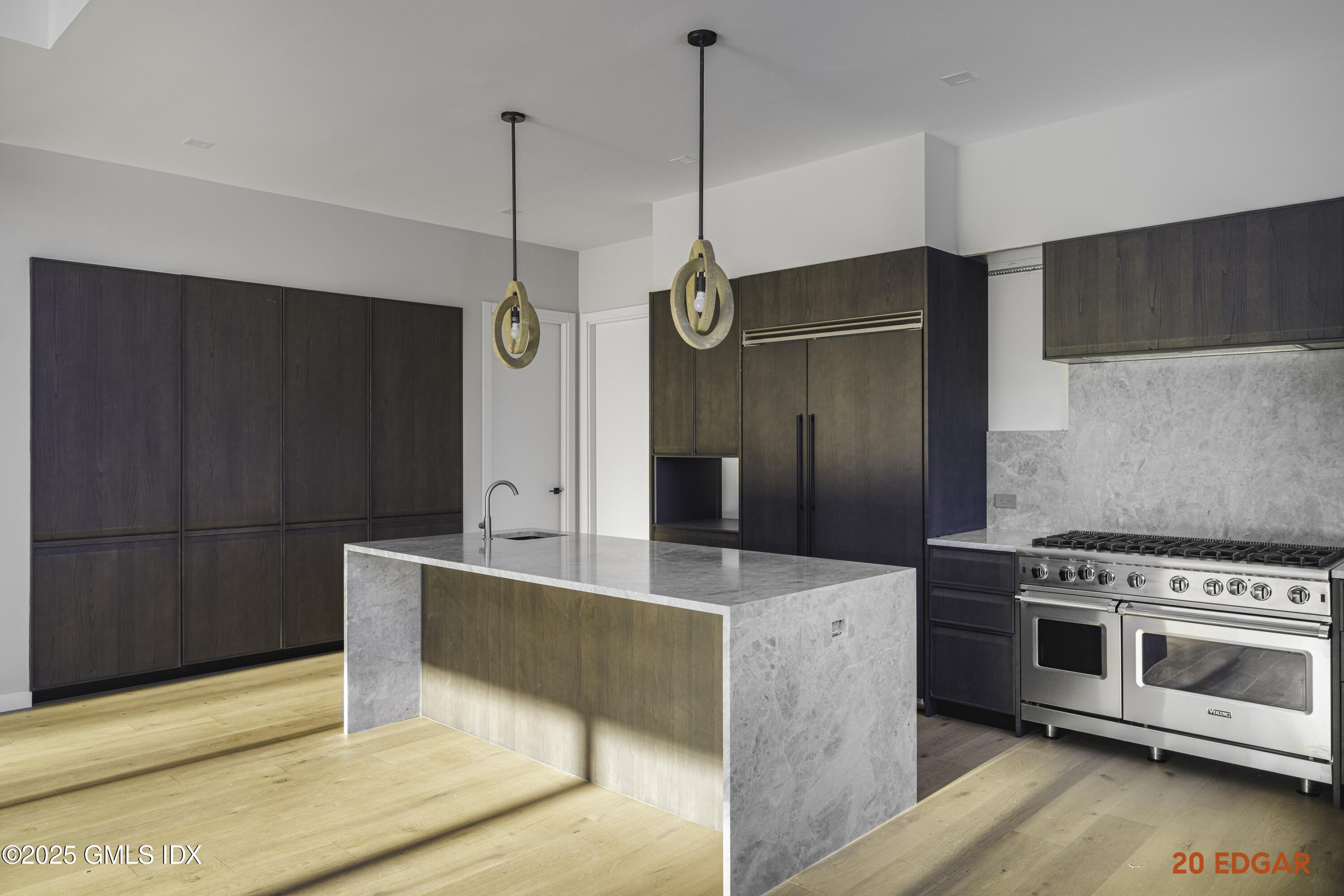 18 Edgar Road Greenwich, CT 06831 - Photo 11 of 23 a kitchen with stainless steel appliances granite countertop a refrigerator a oven and a wooden floors