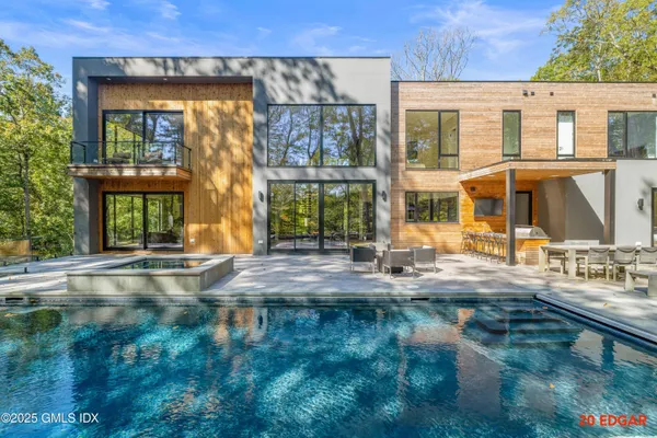 a view of swimming pool with outdoor seating and plants