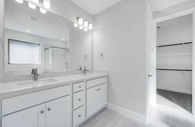 a bathroom with a sink a vanity and a mirror