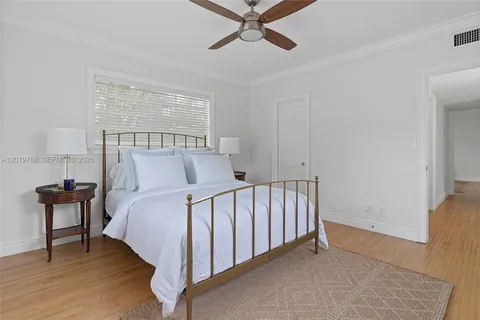 a bed sitting in a bedroom next to a window