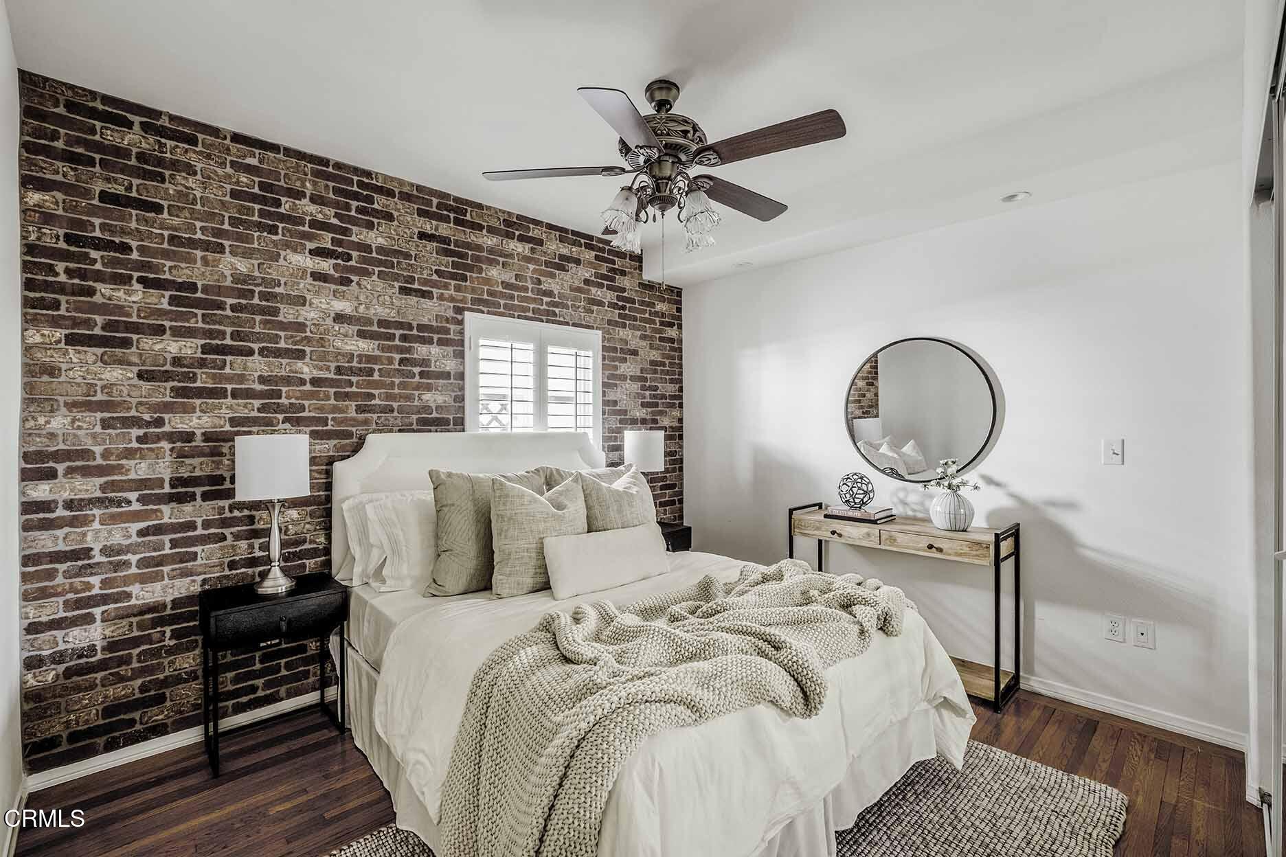 1779 Morada Place Altadena, CA 91001 - Photo 22 of 54 a bedroom with a bed and wooden floor