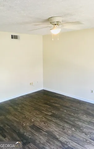 a view of a room with wooden floor