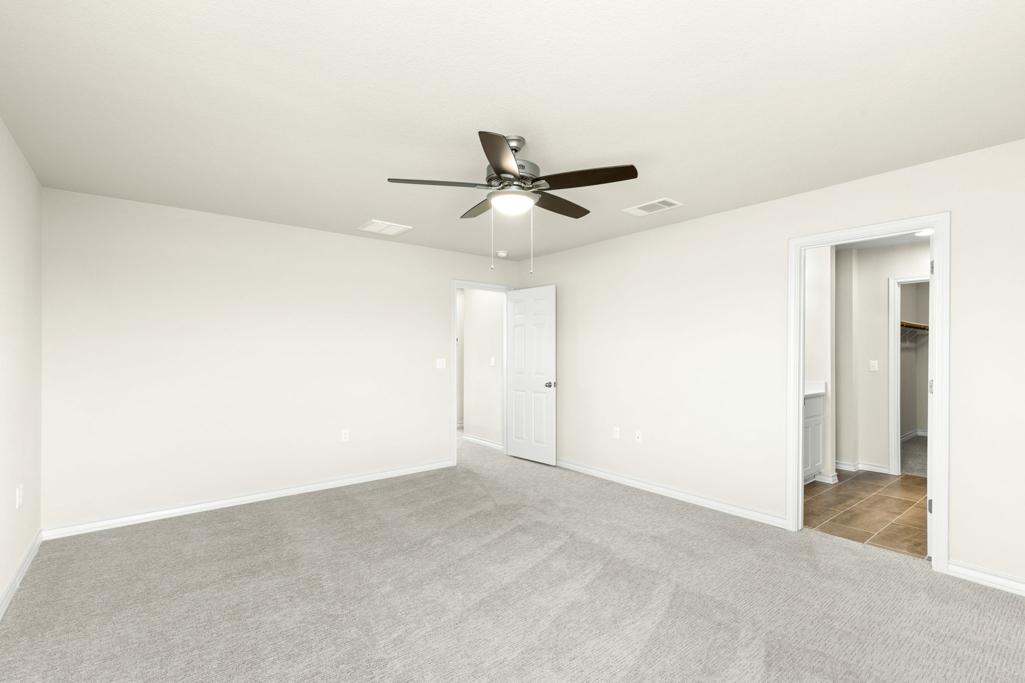 1624 Caballo Blanco Road Austin, TX 78725 - Photo 17 of 27 Plush carpeting and neutral walls define this versatile secondary bedroom space.