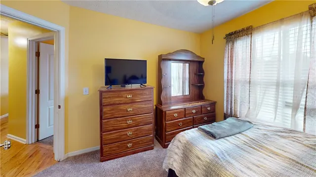 a bedroom with a bed and a dresser