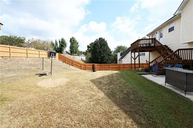 a backyard of a house with table and chairs