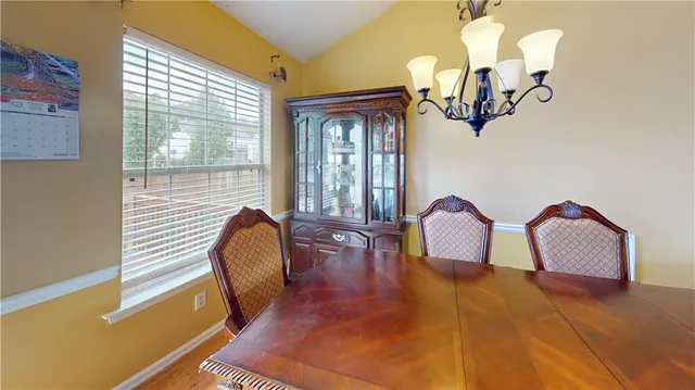 a view of a room with a large window and chandelier