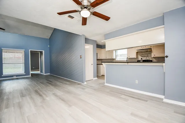 a view of a kitchen with a sink and cabinets