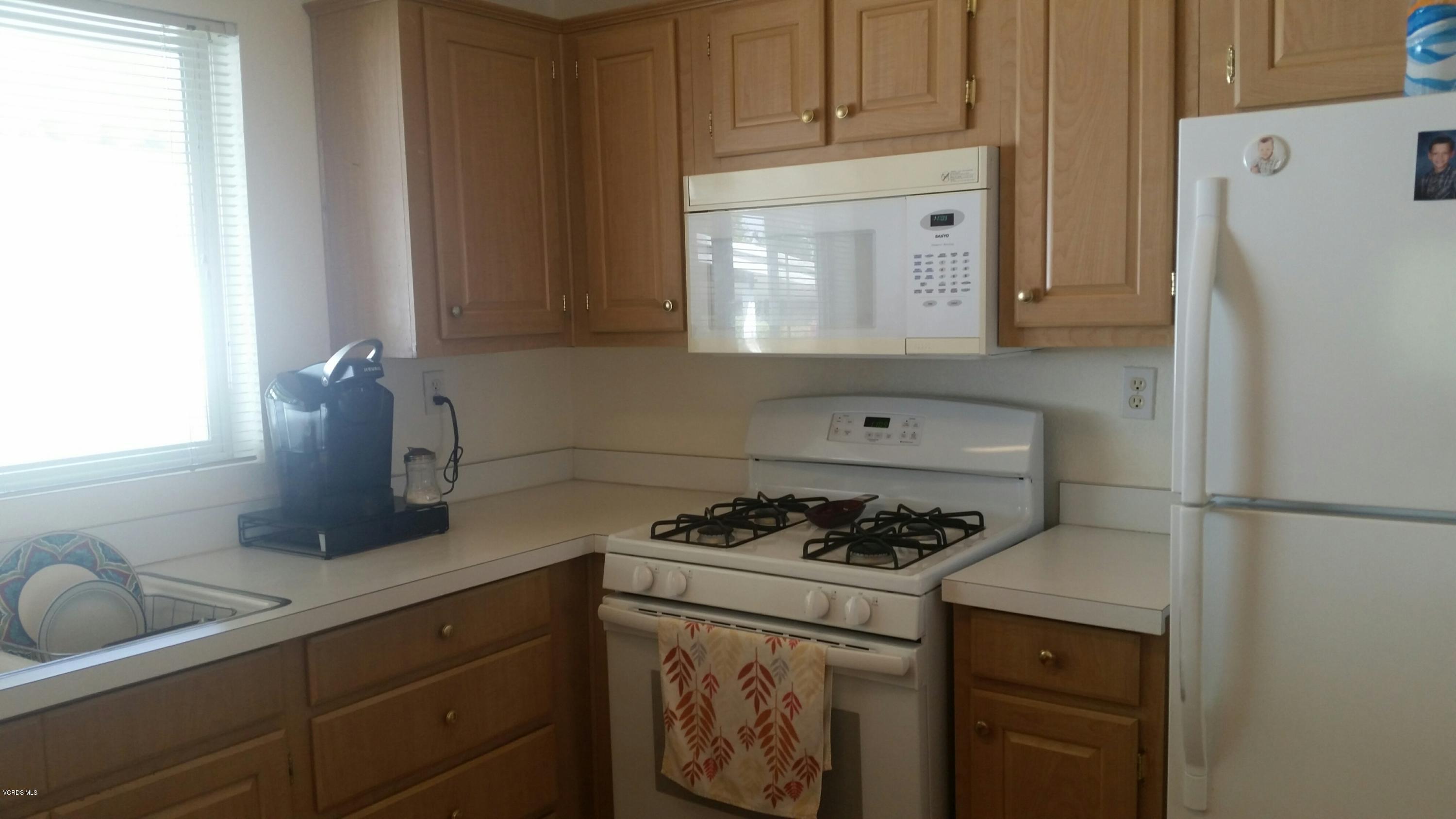 6480 Katherine Road, Unit 23 Simi Valley, CA 93063 - Photo 16 of 37 a kitchen with a refrigerator and a sink