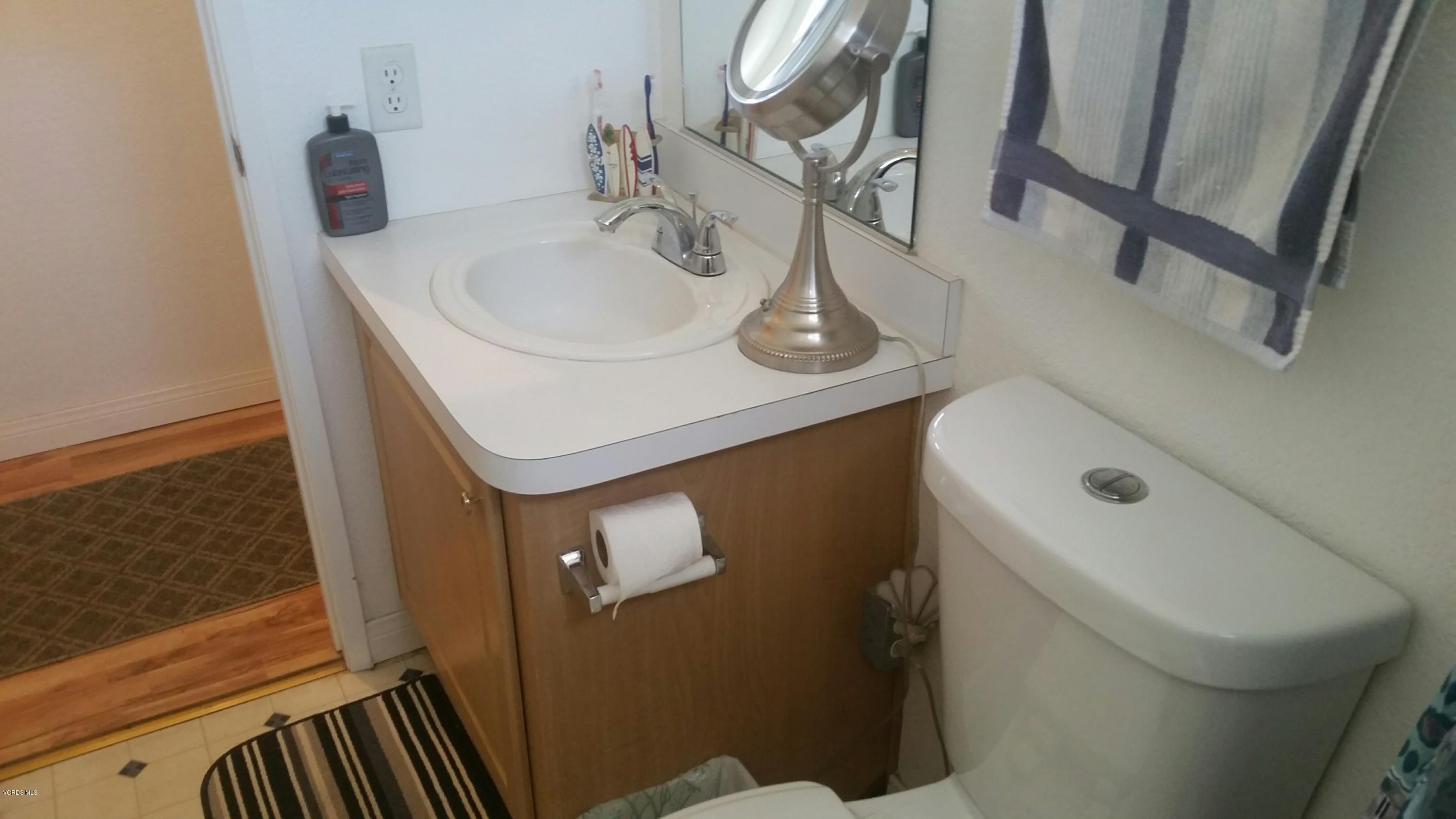 6480 Katherine Road, Unit 23 Simi Valley, CA 93063 - Photo 20 of 37 a bathroom with a sink and a mirror