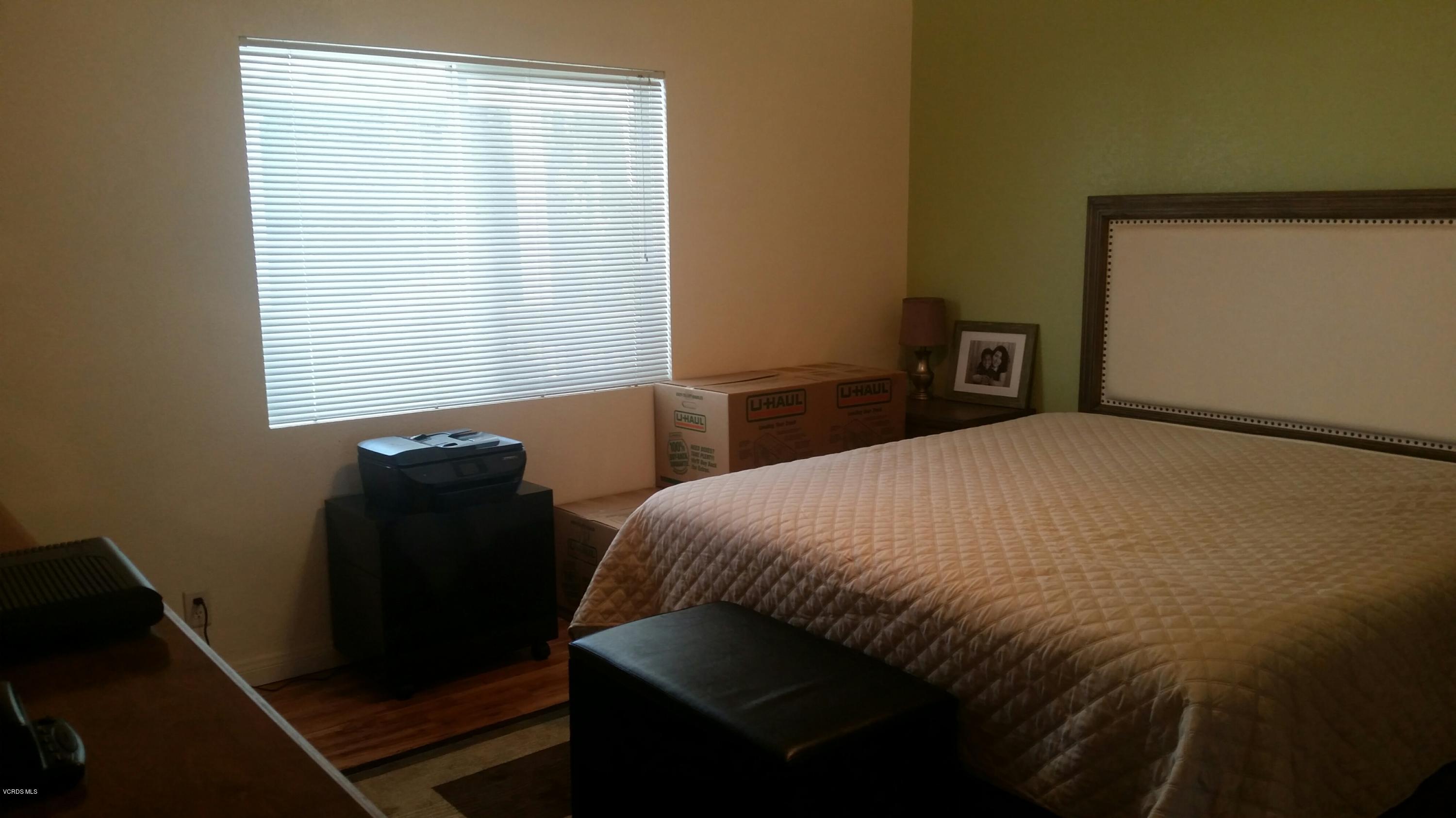 6480 Katherine Road, Unit 23 Simi Valley, CA 93063 - Photo 23 of 37 a bedroom with a bed and a window