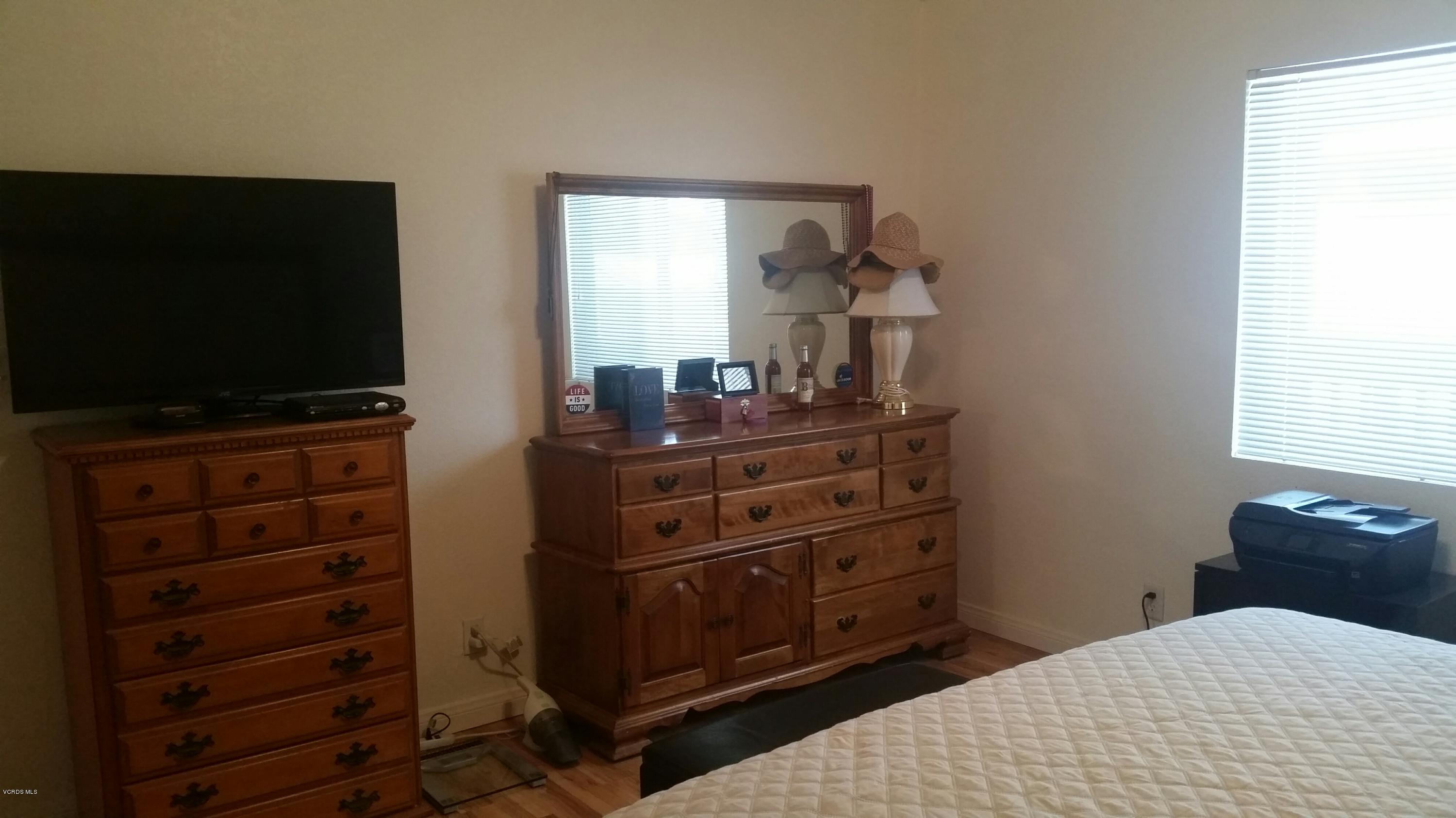 6480 Katherine Road, Unit 23 Simi Valley, CA 93063 - Photo 24 of 37 a bedroom with a bed and furniture
