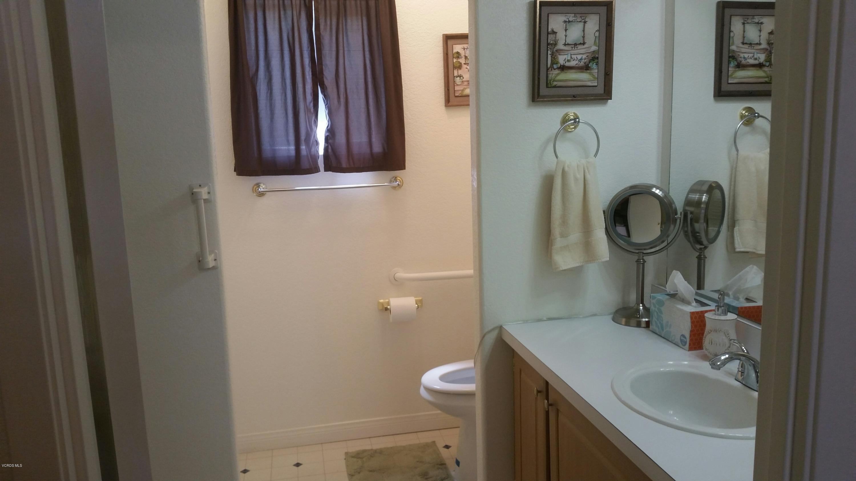 6480 Katherine Road, Unit 23 Simi Valley, CA 93063 - Photo 26 of 37 a bathroom with a toilet a sink and mirror