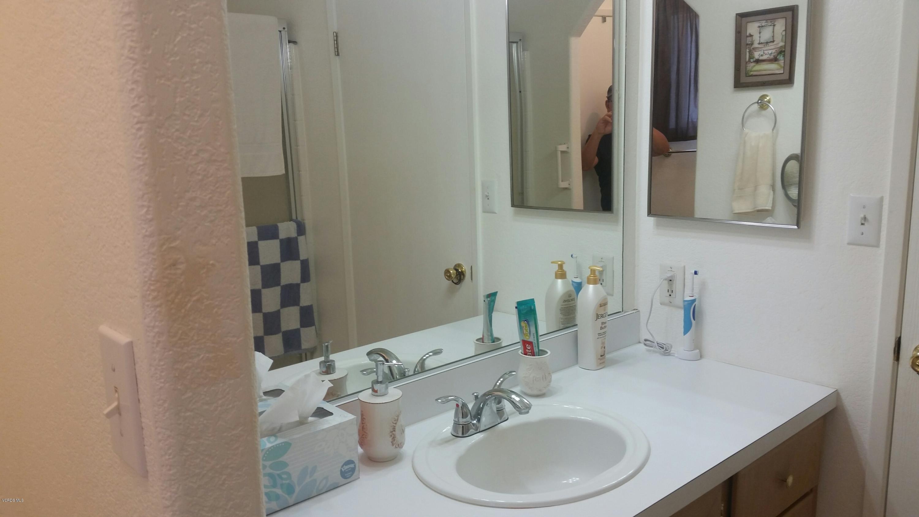 6480 Katherine Road, Unit 23 Simi Valley, CA 93063 - Photo 27 of 37 a bathroom with a sink and a mirror