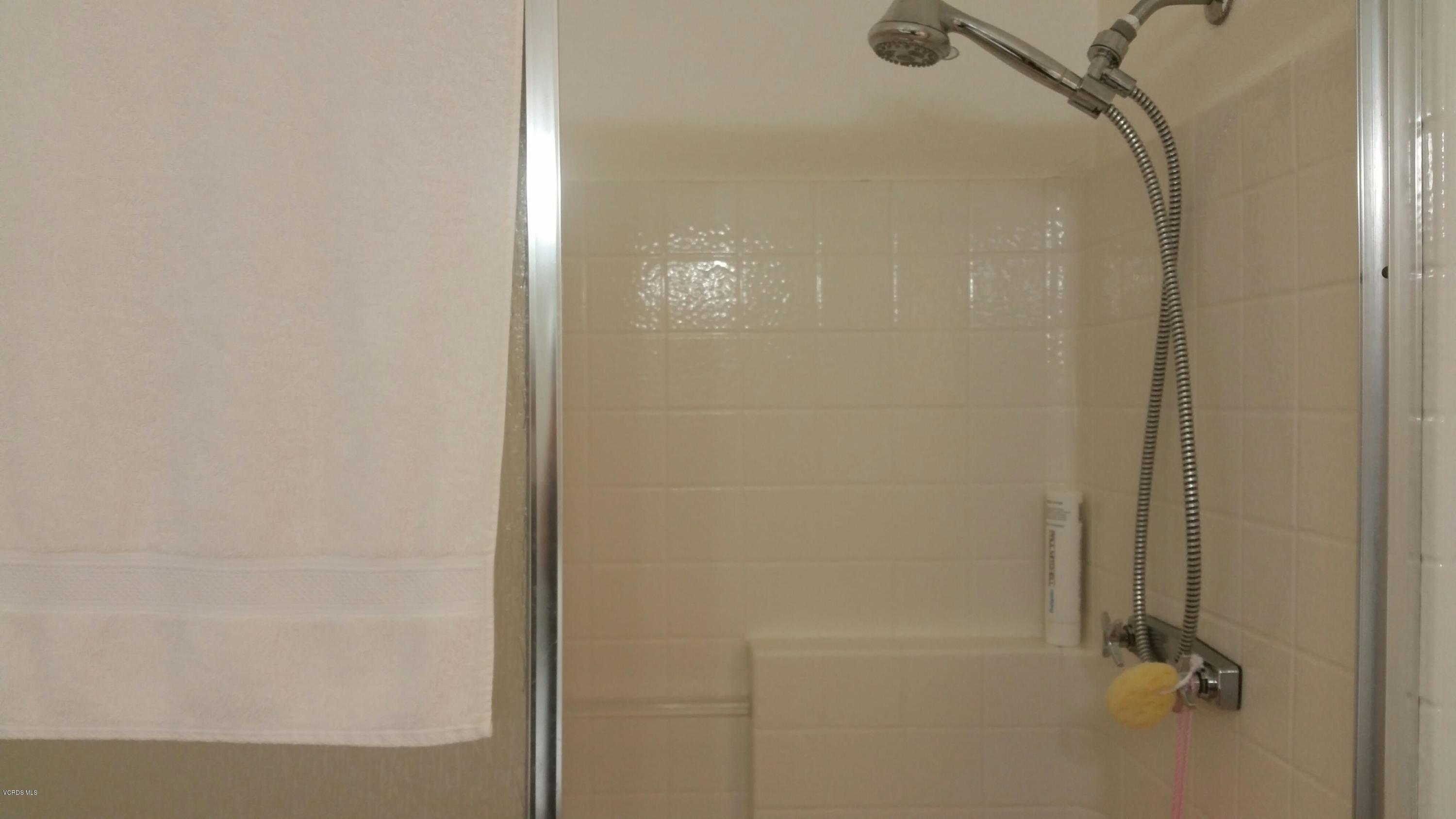6480 Katherine Road, Unit 23 Simi Valley, CA 93063 - Photo 32 of 37 a bathroom with a glass shower door