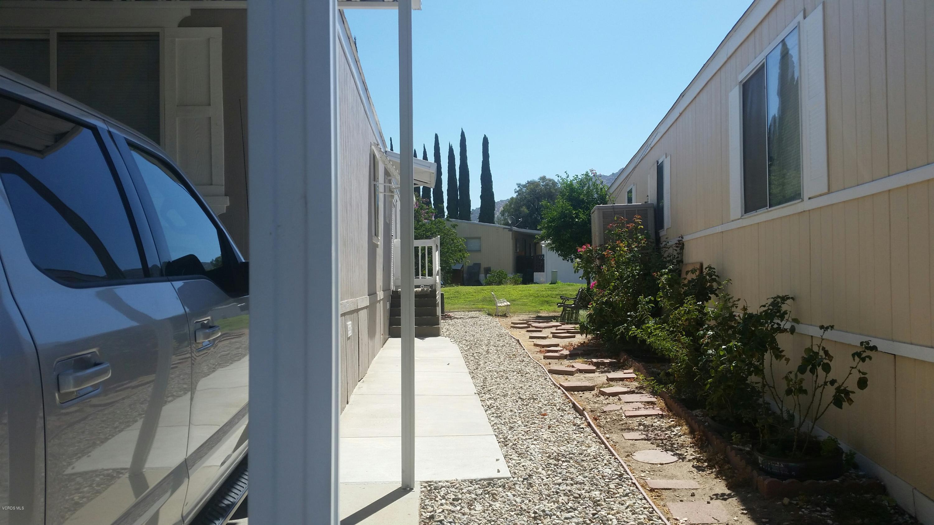 6480 Katherine Road, Unit 23 Simi Valley, CA 93063 - Photo 8 of 37 a view of a pathway both side of house